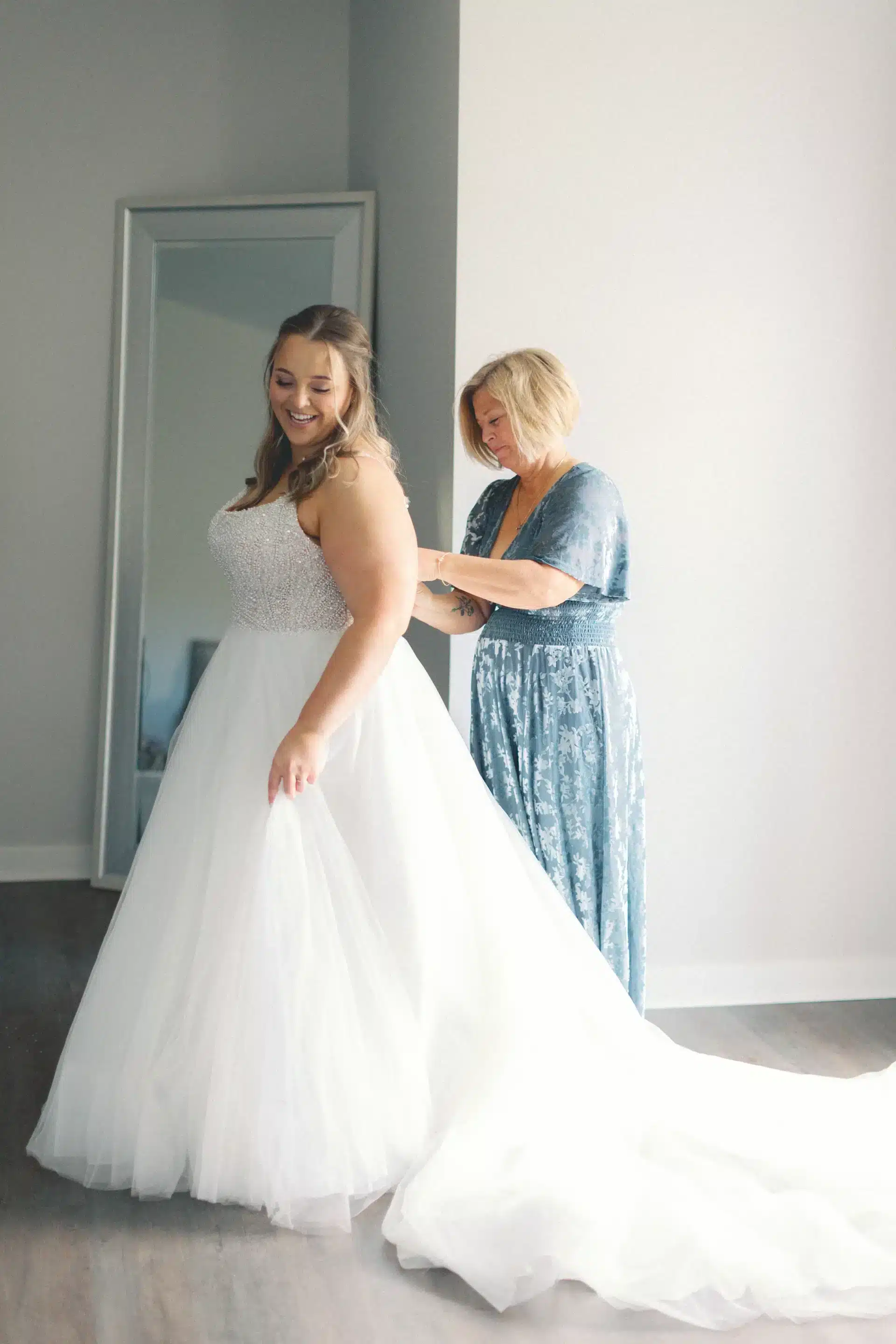 Mom Teaching Daughter How To Bustle A Wedding Dress Mom Teaching Daughter How To Bustle A Wedding Dress