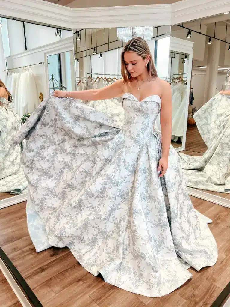 Bride Trying On Non Traditional Wedding Dress With Floral Print