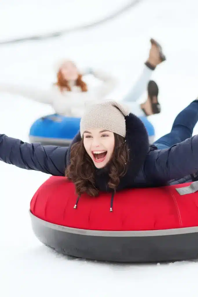 Women Snow Tubing In Winter For Bachelorette Trip
