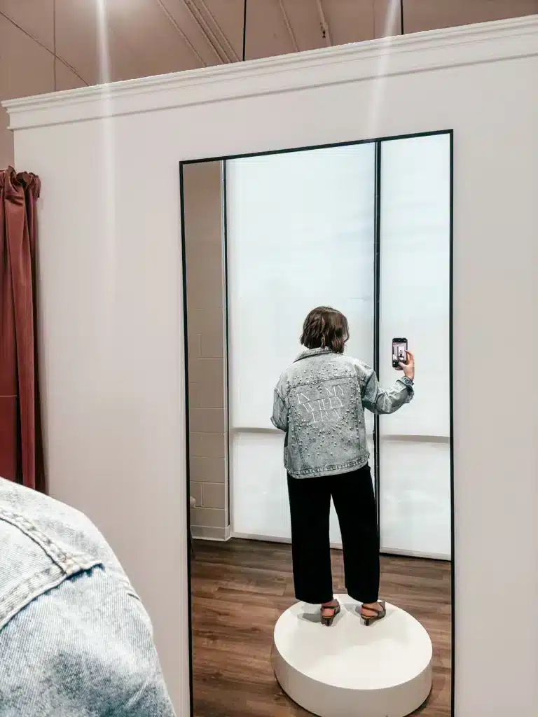 Women Taking Mirror Selfie Of Bride Jean Jacket Accessory