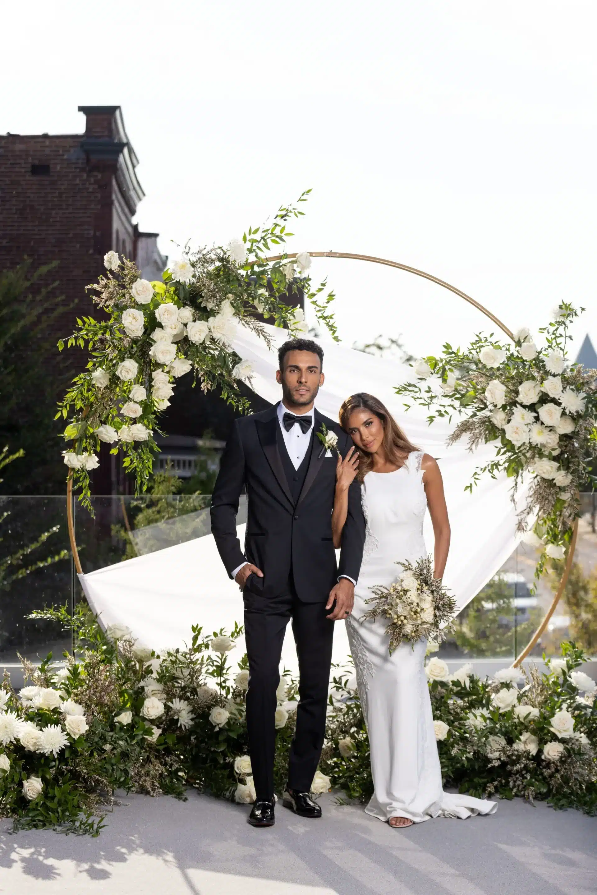 Bride And Groom Posing For Image In Front Of Decor Bride And Groom Posing For Image In Front Of Decor
