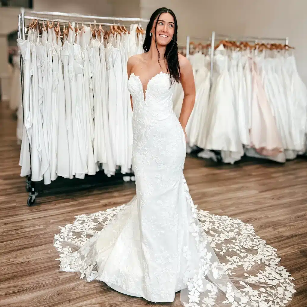 Bride Wearing Sleeveless Fit And Flare Wedding Dress With Lace And Circular Lace Train In Store