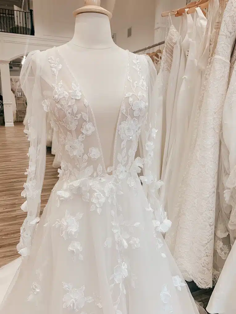 Close Up Of Wedding Dress With Deep V Neck And Floral Embellishments