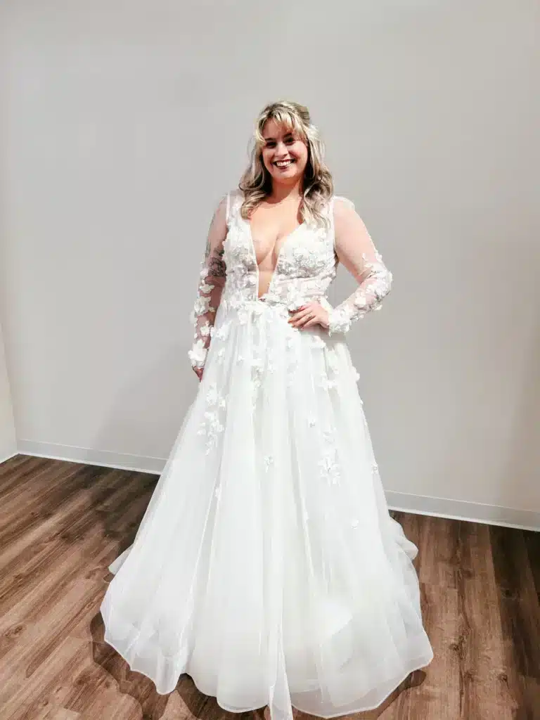 Bride Trying On Dress With Lace Sleeves At Sophias Bridal And Tux