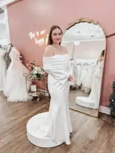 Bride Trying On Off The Shoulder Long Sleeve Wedding Dress