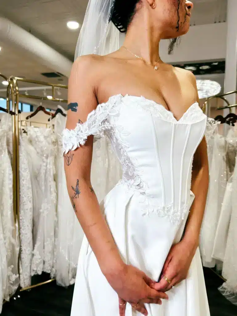 Close Up Of A Client Wearing A Basque Waist Wedding Dress At Sophias Bridal