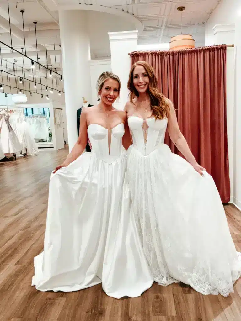 Two Bridal Clients Trying On Basque Waist Wedding Dresses At Sophias Bridal Boutique In Indianapolis
