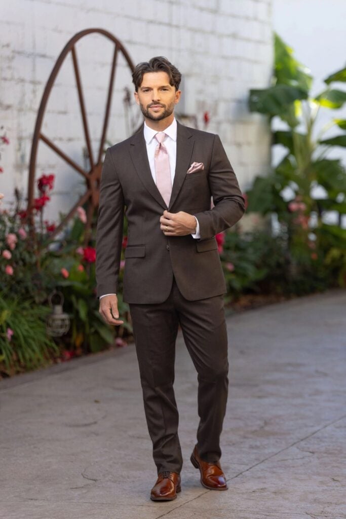 Dark brown wedding suit with pink tie and matching pocket square