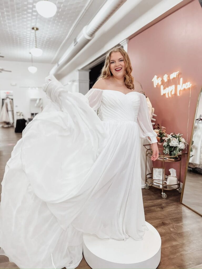 Bride spinning in a flowy chiffon reception dress